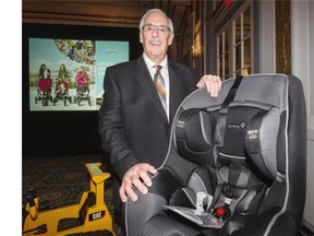 Dorel Industries President and CEO Martin Schwatrz with a Safety 1st Advance SE Convertible car seat.