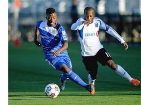 FC Edmonton’s Hanson Boakai, left, and Montreal Impact’s Sanna Nyassi chase the ball during the Amway Canadian Championship semi-final game at Clarke Field on Wednesday May 7, 2014.