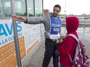 An STM employee directs a commuter to a temporary bus stop at the Fairview Pointe-Claire bus terminal, May 16.