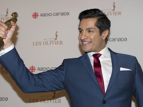 Sugar Sammy holds up his trophy for best comedian of the year at the Gala Olivier awards ceremony in Montreal, Sunday, May 11, 2014.