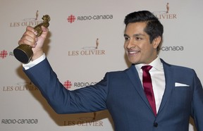 Sugar Sammy holds up his trophy for best comedian of the year at the Gala Olivier awards ceremony in Montreal, Sunday, May 11, 2014.