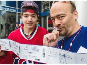Fanatical Habs fans Maxime Perreault, 19, and Bruno Paulin display their tickets, in Montreal, on Tuesday, May 13, 2014, to tomorrow’s broadcast of the Canadiens / Bruins game 7. For $10, fans get to watch the game on the Bell Centre big screen and all the money goes to the Montreal Canadiens Children’s charity.
