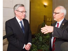 Finance minister Joe Oliver, left, listens to his provincial counterpart Quebec finance minister Carlos Leitão, right, Tuesday, May 20, 2014 in Quebec city.