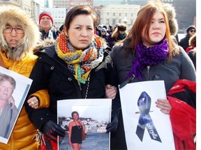 From left: Paningvak Kruse, Aili Liimakka Laue and Sarah Jancke, hold pictures of Loretta Saunders at a vigil on Parliament Hill in March honouring Loretta Saunders and other missing and murdered indigenous women.  Saunders, an Inuk university student writing her thesis on missing and murdered aboriginal women, was killed on the same day native women delivered a petition with 23,000 signatures to Parliament, demanding a national inquiry into the issue.