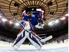 Henrik Lundqvist of the New York Rangers looks on during warm-up prior to the game against the Pittsburgh Penguins during Game Four of the Second Round in the 2014 NHL Stanley Cup Playoffs at Madison Square Garden on May 7, 2014 in New York City.