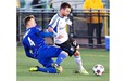 Impact’s Jack McInerney is tackled by Edmonton FC’s Neil Hlavaty during second-half action of the Amway Canadian Championship semifinal in Edmonton on Wednesday.