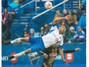 Impact’s Matteo Ferrari, top, collides with the Union’s Andrew Wenger in Montreal on April 26. Montreal earned its first win of the season in the game against Philadelphia.