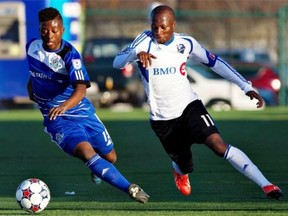 Impact’s Sanna Nyassi chases Edmonton FC’s Hanson Boakai as he controls the ball during first half action of the Amway Canadian Championship semifinal in Edmonton, Alta., on Wednesday May 7, 2014.