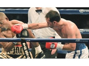 Joachim Alcine, left, gets hit with a right hand from Delvin Rodriguez during a boxing card at the Olympic Stadium in Montreal, Friday May 16, 2014. The fight ended in a draw.