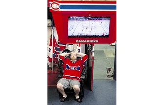 Kris Ireland has his easy chair set up watching a Montreal Canadiens playoff game. He's a member in this shrine know as the Western Canadian Montreal Canadien's Fan Club.