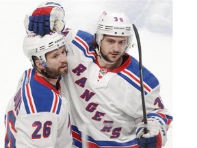 Martin St. Louis (left) of the New York Rangers is congratulated by teammate Mats Zuccarello at the end of the teams’s 7-2 victory over the Canadiens in the first game of the Eastern Conference Final of the NHL playoffs at the Bell Centre in Montreal on Saturday.