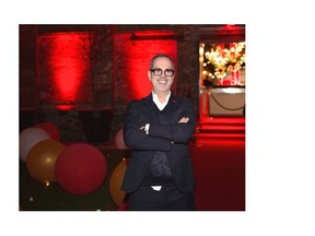 Master Ambiance: Dick Walsh, poses at the grand entrance to his fantastically decorated red and white themed 10th annual Gala Benefit Eve for the Canadian Red Cross, Quebec Division.