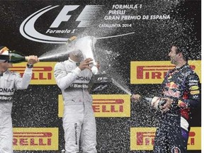 Mercedes-AMG’s German driver  Nico Rosberg, left, Mercedes-AMG’s British driver Lewis Hamilton and Red Bull Racing’s Australian driver Daniel Ricciardo celebrate on the podium after the Spanish Formula One Grand Prix on Sunday at the Circuit de Catalunya in Montmelo on the outskirts of Barcelona.