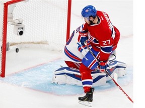 Montreal Canadiens centre Alex Galchenyuk, right, scores against New York Rangers goalie Henrik Lundqvist during Game 5 of the NHL Eastern Conference Final at the Bell Centre in Montreal on Tuesday May 27, 2014.