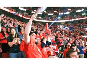 Montreal Canadiens fans celebrate the Habs first goal while watching Game 7 of Stanley Cup series against the Bruins in Boston, on the big screens at the Bell Centre in Montreal Wednesday May 14, 2014.