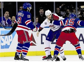 Montreal Canadiens forward Brandon Prust, centre, and New York Rangers forward Daniel Carcillo, left, were both suspended by the league.