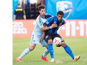 Montreal Impact’s Santiago Gonzalez, right, and Sporting Kansas City’s Benny Feilhaber battle for the ball during second half MLS soccer action in Montreal, Saturday, May 10, 2014.