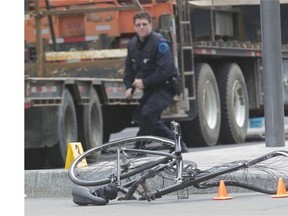A mangled bicycle marks the spot where a cyclist was struck by a flatbed truck at St-Urbain St. and de Maisonneuve Blvd. W. on Thursday.