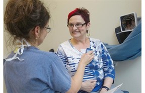 A nurse from The Montreal Heart Institute is monitoring the heart of patient Louise Leduc, right, who just few minutes before had a heart monitor implanted. The institute becomes the first in Quebec to use the heart monitor, which can be inserted under the skin in about 10 minutes and provides continuous information via wireless technology. Dr. Peter Guerra demonstrated the technique with patient Louise Leduc on May 13, 2014