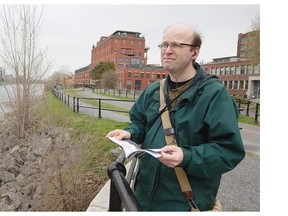 Concordia oral history professor Steven High listens to oral history tour at the St. Gabriel Locks of the Lachine Canal, near the Des Seigneurs Bridge, on Friday May 09, 2014.