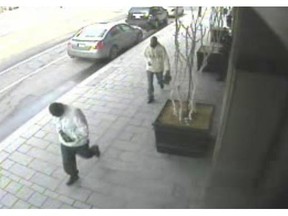 A video released by police shows two suspects walking calmly down the street in the minutes following the shooting at the Flawnego boutique in March 2010.