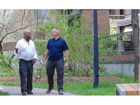 Darrell Helyar, right, president of the Victor Hugo Residents’ Association and Ed Nurse, a longtime resident and community activist, walk in the park at the corner of Lucien-Lallier and St-Jacques, which is an unofficial community centre for the people of the association.