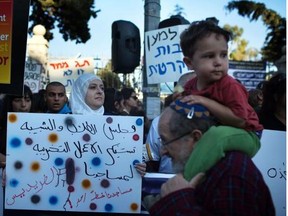 Israeli Muslims, Christians and Jews hold placards during a joint-protest against the increase of attacks on Arabs by Jewish extremists on Sunday outside Israeli Prime Minister's residence in Jerusalem. In 2008, far-right Jewish settlers and other extremists adopted a policy of attacking Palestinians and their property in the West Bank in order to exact a "price" for state moves to take down illegally built settler outposts.