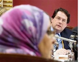 Former PQ minister Bernard Drainville listens to Samira Laouni at a legislature committee studying the proposed charter of values on Tuesday, Jan. 14, 2014 in Quebec City. If the charter had been ruled unconstitutional, it wouldn’t have mattered until after the election, and then only if the PQ won.