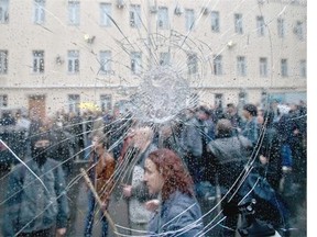 Pro-Russian demonstrators, seen through the cracked window of a police van, stand in the grounds of a police station in Odessa, Ukraine, on Sunday, May 4, 2014. Several prisoners who were detained during clashes that erupted Friday between pro-Russians and government supporters in the key port on the Black Sea coast were released under the pressure of protesters who broke into a police station and received a hero’s welcome by crowds.