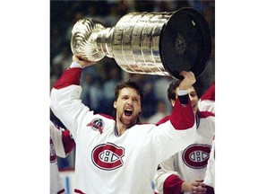 Patrick Roy holds the Stanley Cup aloft after the Canadiens won the Stanley Cup in 1993.  The Canadiens won an unprecedented 10 consecutive overtime games en route to their improbable Stanley Cup win in 1993.