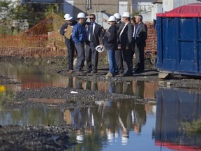 Québec environment minister Yves-François Blanchet, third from left, tours a PCB storage facility with ministry officials in Pointe Claire last September.