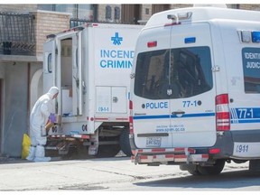 Police investigators work outside a home on Robertine Barry St. in the Cartierville area of Montreal Sunday, May 18, 2014, after police discovered and defused improvised explosive devices (IEDs) found in a unit of the Cartierville triplex Saturday morning.