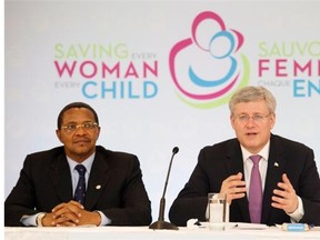 Prime Minister Stephen Harper, right, and Jakaya M. Kikwete, left, President of the United Republic of Tanzania, speak with each other during a photo opportunity as they attend the Maternal, Newborn and Child Health Summit in Toronto on Wednesday, May 28, 2014.