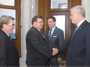 Quebec Premier Philippe Couillard meets Quebec City Mayor Regis Labeaume, left and Montreal mayor Denis Coderre, second left, as Quebec municipal affairs minister Pierre Moreau looks on, on Tuesday, May 6, 2014 in Quebec City.