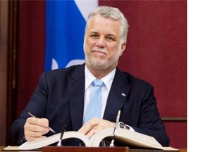 Quebec Premier Philippe Couillard is sworn in during a ceremony Wednesday, April 23, 2014 at the legislature in Quebec City.