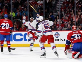 Rangers’ Martin St. Louis celebrates with teammate Carl Hagelin after scoring a first-period goal against the Canadiens in Game 1 of the Eastern Conference Final at the Bell Centre on Saturday.