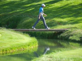 Rory McIlroy of Northern Ireland walks over a bridge on the 14th hole during the second round of the Memorial Tournament presented by Nationwide Insurance at Muirfield Village Golf Club on May 30, 2014 in Dublin, Ohio.