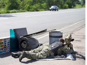 A Pro-Russian gunman takes his position with an anti-tank rocket launcher preparing to fight against Ukrainian government troop at a checkpoint blocking the major highway which links Kharkiv, outside Slovyansk, eastern Ukraine, Friday, May 16, 2014. Outside the strategic city of Slovyansk, which  has been the key stronghold of the pro-Russian insurgents for more than a month now, the armed separatists installed a new check-point on the eastern approaches of the city blocking the major highway which links Kharkiv, the capital of the neighboring region, and the Russian city of Rostov-on-Don across the border.