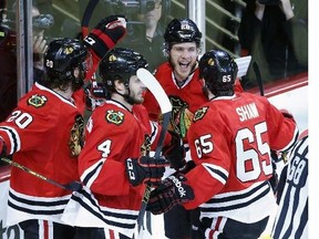 Chicago Blackhawks right wing Ben Smith, second from right, celebrates with his teammates after scoring a goal against Los Angeles Kings during the third period in Game 5 of the Western Conference finals in the NHL hockey Stanley Cup playoffs Wednesday, May 28, 2014, in Chicago.