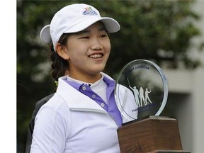 Girls 10-11 category champion Lucy Li from Redwood City, California poses with her trophy during the National Finals of the 2014 Drive, Chip and Putt Championships April 6, 2014 at Augusta National Golf Club in Augusta, Georgia.