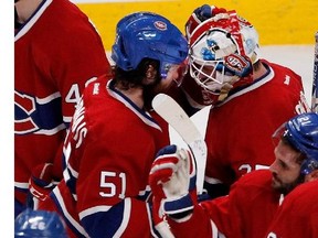 Canadiens centre David Desharnais congratulates goalie Dustin Tokarski after Montreal beat the Rangers 7-4 during Game 5 of the Eastern Conference final at the Bell Centre on Tuesday.