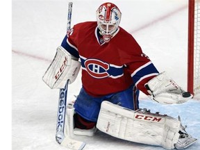 Canadiens goalie Carey Price gets pushed back into his net as defenceman Josh Gorges scrambles to help out while Bruins’ Milan Lucic and Gregory Campbell crash the crease Tuesday night at the Bell Centre.