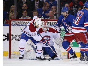 Dustin Tokarski (35) and Mike Weaver (43) of the Montreal Canadiens defend the net against Chris Kreider (20) of the New York Rangers during Game Six of the Eastern Conference Final in the 2014 NHL Stanley Cup Playoffs at Madison Square Garden on May 29, 2014 in New York City.