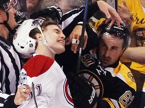 Brad Marchand gets the glove up on Brendan Gallagher during the first period of Game 5 on Saturday.