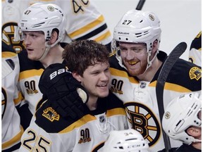 Boston Bruins' Matt Fraser (25) celebrates with teammate Dougie Hamilton after scoring the winning goal against the Montreal Canadiens during the first overtime period in playoff action Thursday, May 8, 2014 in Montreal.