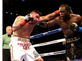 Montrealer Bermane Stiverne, right, battles Chris Arreola in their WBC Heavyweight Championship match in Los Angeles on Saturday.  Stiverne won in a six round technical knockout.