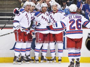 Ryan McDonagh (27), Chris Kreider (20), Brad Richards (19), Derek Stepan (21) and Martin St. Louis (26), all of the New York Rangers, celebrate Richards's second period power-play goal against the Pittsburgh Penguins in Game Seven of the Second Round of the 2014 NHL Stanley Cup Playoffs on May 13, 2014 at CONSOL Energy Center in Pittsburgh, Pennsylvania.