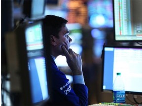 Trader works on the floor of the New York Stock Exchange: Dimensional Fund Advisors uses a strategy based around academic research, patience and discipline, noting that individual investors fall victim to their own emotions and get in and out of stocks at the wrong time.