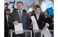 Ukrainian presidential candidate Petro Poroshenko, left,  and his wife Maria, right, cast their ballots at a polling station during the presidential election in Kiev, Ukraine, Sunday, May 25, 2014. Ukraine’s critical presidential election got underway Sunday under the wary scrutiny of a world eager for stability in a country rocked by a deadly uprising in the east.