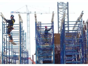 Workers at a construction project on Notre-Dame St. W. in Montreal Tuesday, April 1, 2014.